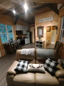 The Chalet is located in the woods of a gated property with a covered porch. - Image 5