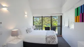 Relax by the pool whilst enjoying the landscaped garden and Laguna Bay views - Image 3