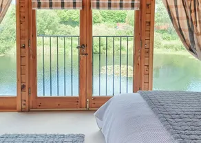 Set in a peaceful location and perched over the lake. - Image 5