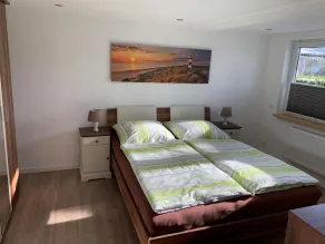 First floor vacation apartment on approx. 78 sqm, high-quality and modern furnishings with furnished terrace with garden pond and barbecue facilities, covered e-bike charging station and lockable bicycle room. You can look forward to: a fully equipped... - Image 4
