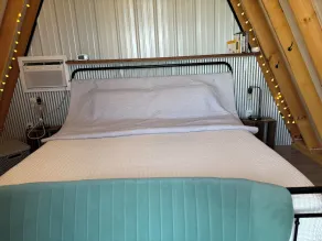 King bed in Tulip Glamping Aframe at Noble Pine Campground - Image 4