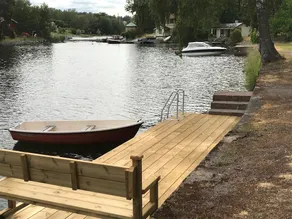 Cottage with sunny wooden deck by water. Rowing boat included. - Image 2