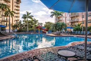 Relax at our Palm Tree secluded Resort with a poolside bar and waterslide - Image 2