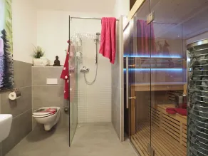 Your oasis of well-being under a thatched roof: a large color-light therapy sauna and a fireplace. - Image 2