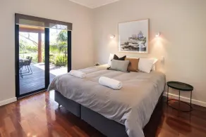 A stylish and modern home, situated in manicured gardens. - Image 3