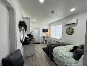 Modern studio apartment with covered outside seating area - Image 5