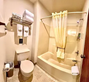 Two queen beds, private bathroom, mini fridge, and single-serve coffee maker. - Image 4