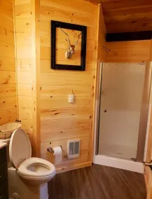 The Chalet is located in the woods of a gated property with a covered porch. - Image 2