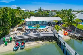 Aquatopia North: Riverfront beach house, w/ dock, heated pool + hot tub & more! - Image 1