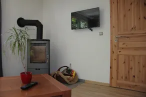 Modernly furnished bungalow with fireplace, surrounded by greenery. - Image 2