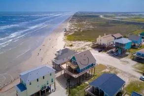 Martinis & Bikinis, a beach front house with toes in the sand drink in the hand. - Image 5