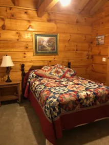 cozy cabin in the woods in a relaxing area with wrap around porch rocking chairs - Image 3