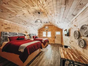 Cabin #4: Two queen-size beds with a kitchenette and a large gravel parking pad beside the cabin for easy boat or trailer storage. - Image 4