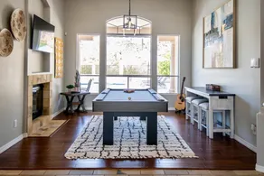Relax and recharge at this stylish desert retreat with views of rolling desert hills. Enjoy sunsets from the heated pool, dine outdoors, or unwind with a few on the putting green. Perfect for long stays—just 15 minutes from the airport! - Image 2