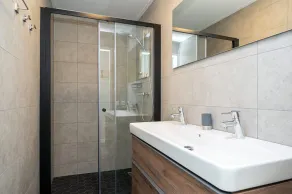 Stay in our Anchor 14 Wellness family home with a sauna, an outdoor spa, and a sunshower. - Image 4