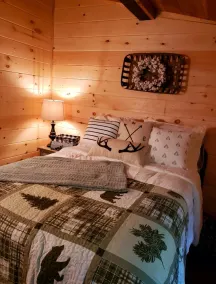 The Chalet is located in the woods of a gated property with a covered porch. - Image 3