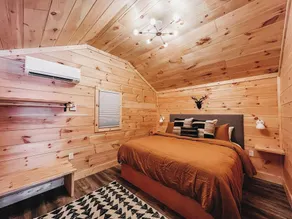 Cabin #9: One king-size bed, a kitchenette, and a large gravel parking pad beside the cabin for easy boat or trailer storage. - Image 3