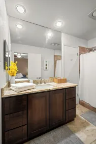 This spacious home has all you need with 2 primary suites, 2 guest bedrooms, and 3 bathrooms. There is no shortage of living space with a living room, 2 dining rooms, open floor plan w/fully-stocked kitchen, and onsite laundry. - Image 4