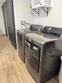 Completely Renovated home comfortably accommodates your stay with a queen bed in the primary bedroom, a twin bed with a pull-out trundle in the second bedroom, and a sleeper sofa in the living room for additional guests. - Image 2