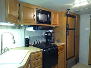 this is  a very spacious RV that sits under 2 large trees - Image 5