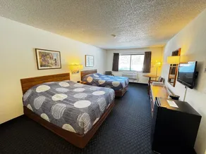 Two queen beds, private bathroom, mini fridge, and single-serve coffee maker. - Image 1