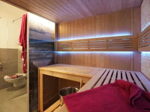 Your oasis of well-being under a thatched roof: a large color-light therapy sauna and a fireplace. - Image 3
