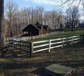 The Chalet is located in the woods of a gated property with a covered porch. - Image 5