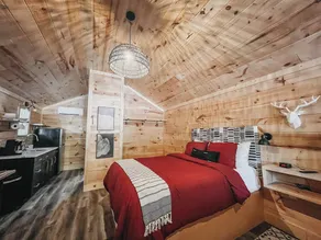 Cabin #4: Two queen-size beds with a kitchenette and a large gravel parking pad beside the cabin for easy boat or trailer storage. - Image 5