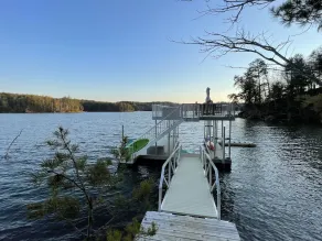 Lake front home with dock in a small cove with a beach. - Image 2