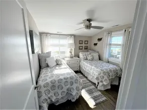 Enjoy water views from the deck overlooking the bay, or get close to the action on the bayfront dock. - Image 4