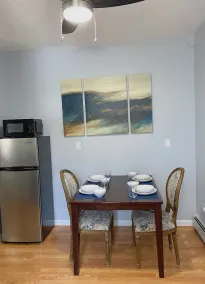 Cozy king suite with kitchen and dining area. - Image 5
