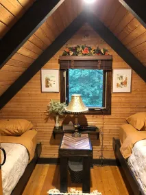 Luxurious secluded rustic wooden chalet on edge of tranquil pond next to beach. - Image 4