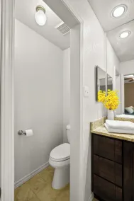 This spacious home has all you need with 2 primary suites, 2 guest bedrooms, and 3 bathrooms. There is no shortage of living space with a living room, 2 dining rooms, open floor plan w/fully-stocked kitchen, and onsite laundry. - Image 3