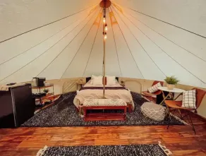 A luxurious glamping tent nestled in the trees. - Image 4