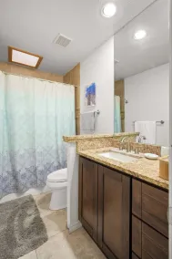 This spacious home has all you need with 2 primary suites, 2 guest bedrooms, and 3 bathrooms. There is no shortage of living space with a living room, 2 dining rooms, open floor plan w/fully-stocked kitchen, and onsite laundry. - Image 5