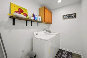 This spacious home has all you need with 2 primary suites, 2 guest bedrooms, and 3 bathrooms. There is no shortage of living space with a living room, 2 dining rooms, open floor plan w/fully-stocked kitchen, and onsite laundry. - Image 2