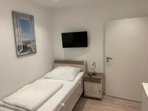 First floor vacation apartment on approx. 78 sqm, high-quality and modern furnishings with furnished terrace with garden pond and barbecue facilities, covered e-bike charging station and lockable bicycle room. You can look forward to: a fully equipped... - Image 5